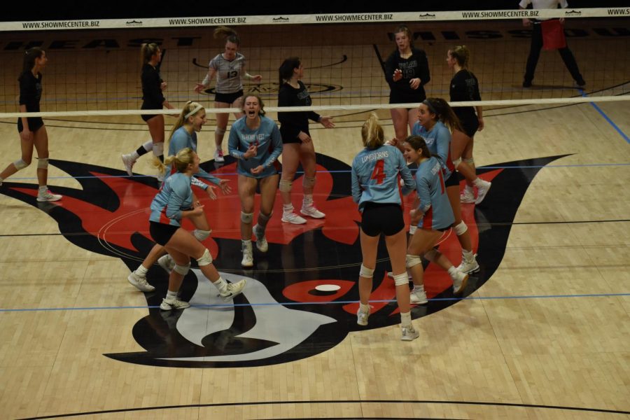 The girls varsity volleyball team came together celebrating a block by senior Maddy Truka (2). The team finished with a record of 12-5 alongside a second place finish at the state tournament. “It still feels surreal, but I couldn’t think of a better way to have ended my senior season,” senior and team captain Carly Kuehl said. “I think going into the season not thinking we would have a season makes it even better. At the beginning, we weren’t really working for an end goal. As we kept moving on and kept winning, my excitement and desire to keep winning grew. I’m just so proud of my team and happy that this is how I got to end my volleyball career.” Photo 
