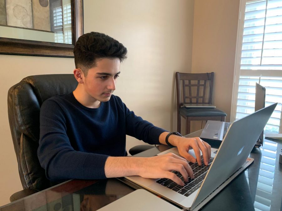 Preparing to execute another deal, junior Kayvon Rezaei examines his stock market portfolio. Rezaei has been trading stocks for over a year and spends time after school every day analyzing graphs and making trades. “The best part about doing the stock market for me is when you work hard and earn the money,” Rezaei said. 