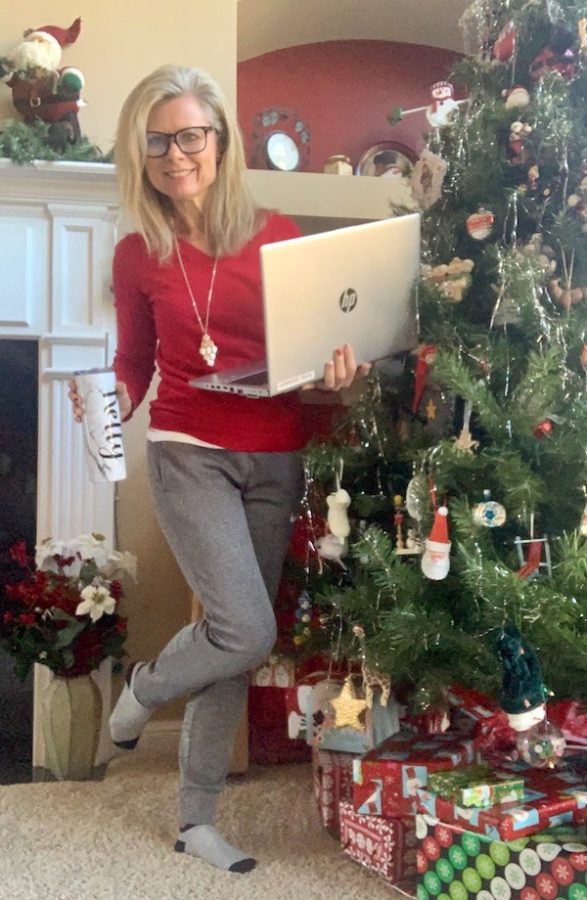 Business teacher Kelly Kennedy smiles with her laptop in preparation for a day of virtual teaching. 