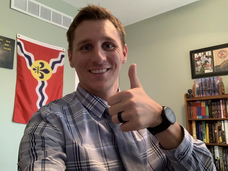 Standing in his at-home classroom, English teacher Kaleb Schumer prepares to teach students in a virtual setting. 