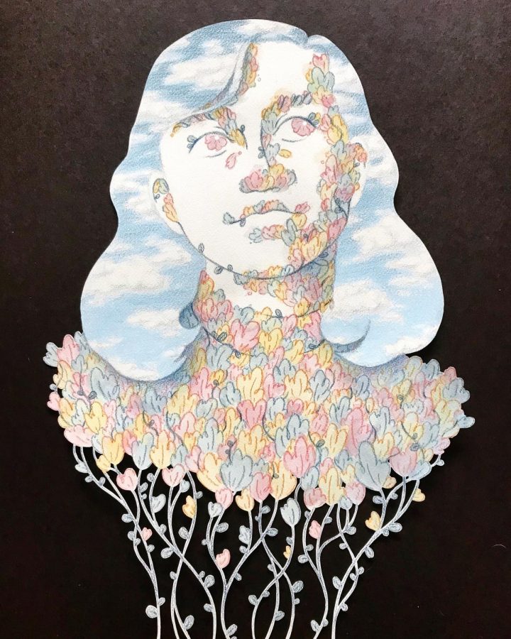 Image description: Using an X-acto knife to carefully make flower and line cut-outs, senior Eva Phillips spent lots of time to create a unique art piece.