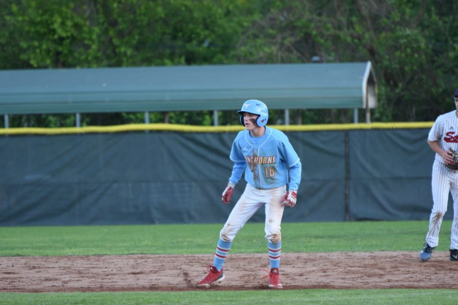 Preparing to run to the next base, senior Elliot Krewson watches the next pitch to the batter. Krewson has been playing baseball since he was 3 years old. "Winning a game, especially when your team is struggling, is a great feeling. However, winning isn't all about the win," Krewson said. “It's about gaining that momentum and just getting closer with the team because when you aren't having a good season, you need little things like that to boost the team."