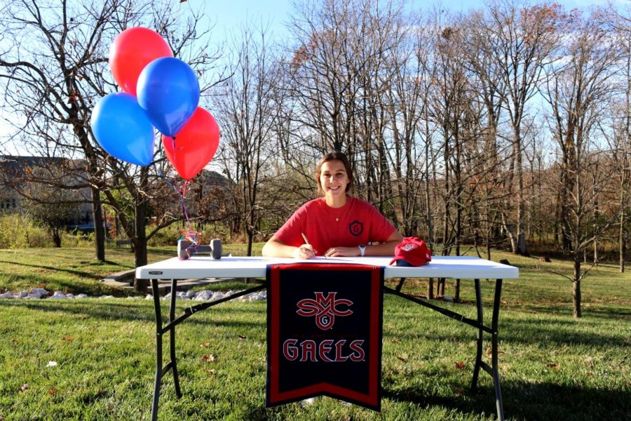 Senior Katie Ferbet signs her national letter of intent to commit to Saint Mary’s College of California Nov. 13. Ferbet had narrowed down her decision to about three schools before she made her final choice. “Once I decided, I told the coach ‘I want to accept your offer’ and thats where I am now. I definitely felt like a weight was lifted off my shoulders,” Ferbet said.