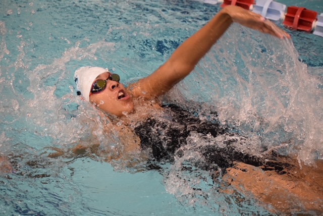 Junior Lauren McLeod, a member of the swim and dive team, gives her all in the 100 backstroke. McLeod has been a part of the varsity swim and dive team for two years, and has been swimming for seven years of her life. "It's a sport that takes a lot of perseverance. But it is also very rewarding to be a part of a team that is so driven and always brings each other up," McLeod said. 