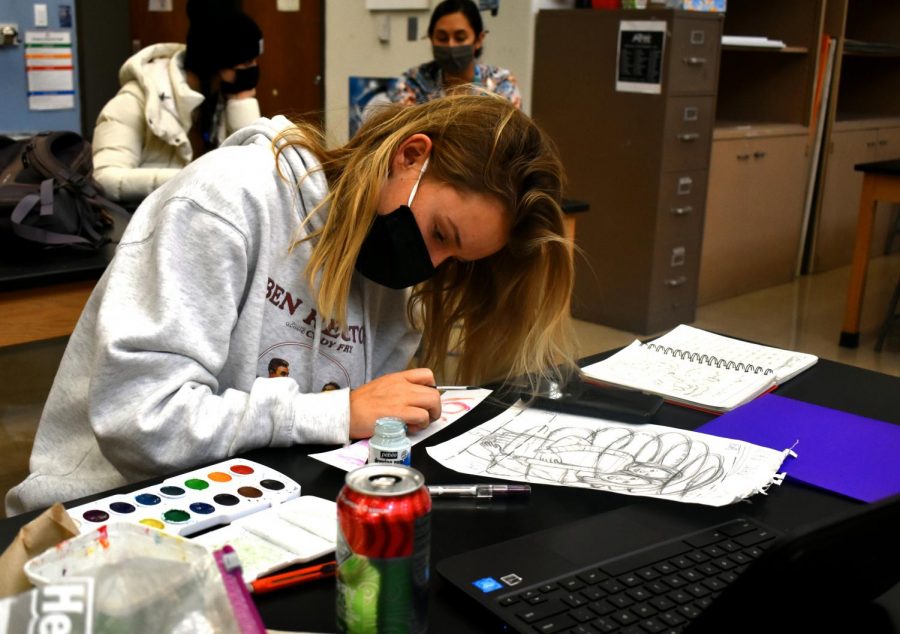 Picking up her paintbrush, senior Claire Hardy works on her next piece for AP Drawing. Hardy centered all of her projects on one sustained investigation question: What impact do people have on me? “We get to choose our topic and the materials we use which is nice because you can make the piece more personal,” Hardy said. “While the freedom of this class is great, it [also] poses a challenge because the options are endless when starting a new project”.