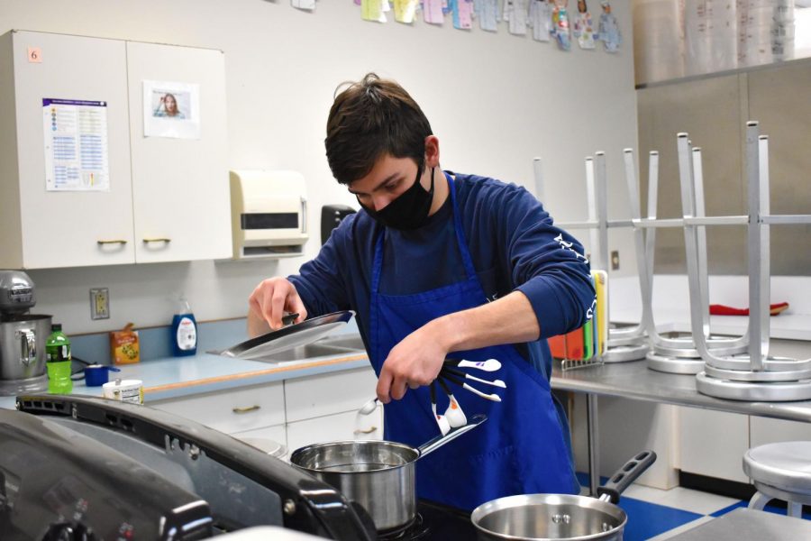 Adding+salt+to+the+water%2C+senior+Donald+Mahoney+carefully+measures+ingredients+to+cook+pasta+in+his+Let%E2%80%99s+Cook+Together+class+Feb.+23.+Mahoney+took+the+class+to+improve+his+cooking+skills%2C+and+so+far+the+biggest+challenge+has+been+making+sure+he+has+everything+he+needs.+%E2%80%9CMy+favorite+recipe+is+the+no-bake+cookies+we+made+once%2C%E2%80%9D+Mahoney+said.+%E2%80%9CI+just+love+all+of+our+cooking+days.%E2%80%9D