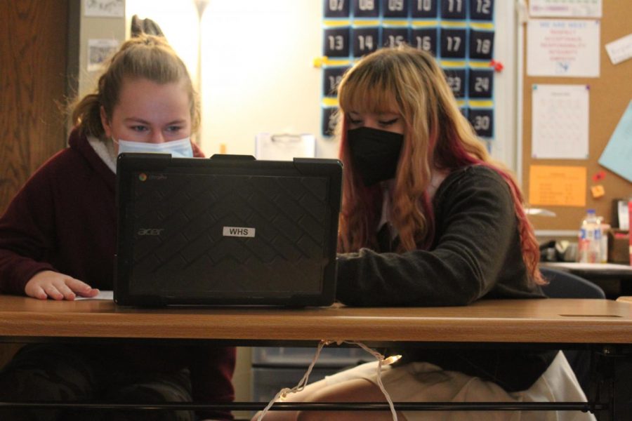 Freshmen Molly Masalskis and Renata Olmos work on their short term project, describing where they live in American Sign Language (ASL) class. ASL is one of Olmos’s favorite  classes. “I made a lot of friends in this class and I like learning the language,” Olmos said.
