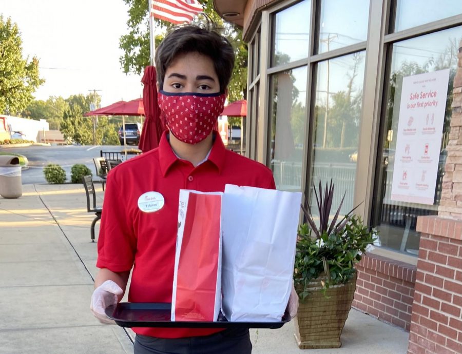 Sophomore Tristan Caudill brings out a customer's order while working at Chick-fil-A. Caudill began his job at the beginning of the school year. “I think working in food service, you have to deal with angry customers as well as waves of customers. Most people were nice, but you had to be prepared for those that were not. There was never time to rest. Chick-Fil-A definitely taught me how to compose myself in stressful situations and how to deal with rude or angry customers.”