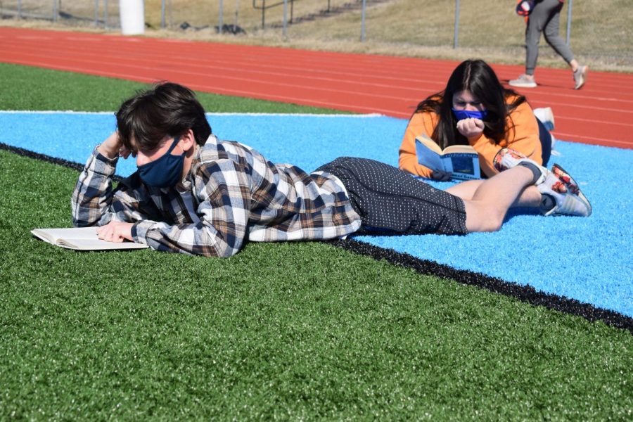 During third hour on Tuesday, junior Matt Givens reads on the football field during his English III class. Givens spent the time catching up on The Great Gatsby while enjoying the warm weather. “Mrs. Kerpash told us we’d be able to go outside because the weather was really nice and she bought footballs, frisbees and other fun things,” Givens said.
