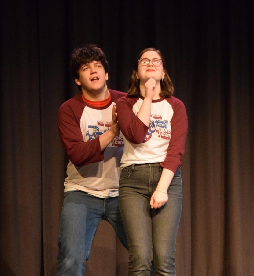 Junior Luke Mathiesen and senior Clare Weaver act out an improv scene during an Improv show in 2019
