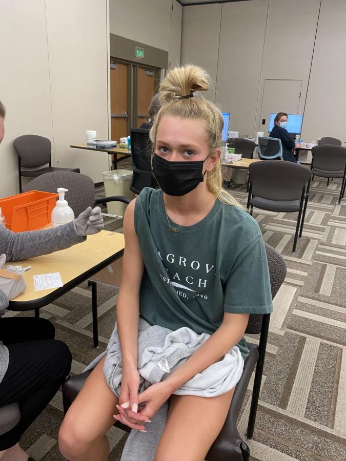 Looking at the camera, junior Megan VanValkenburgh receives the vaccine at a Mercy Clinic. 