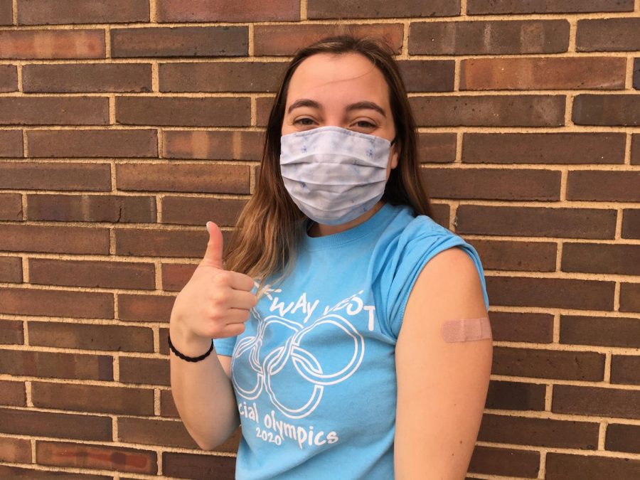 Senior Emma Pence smiles and poses after receiving her first dose. 