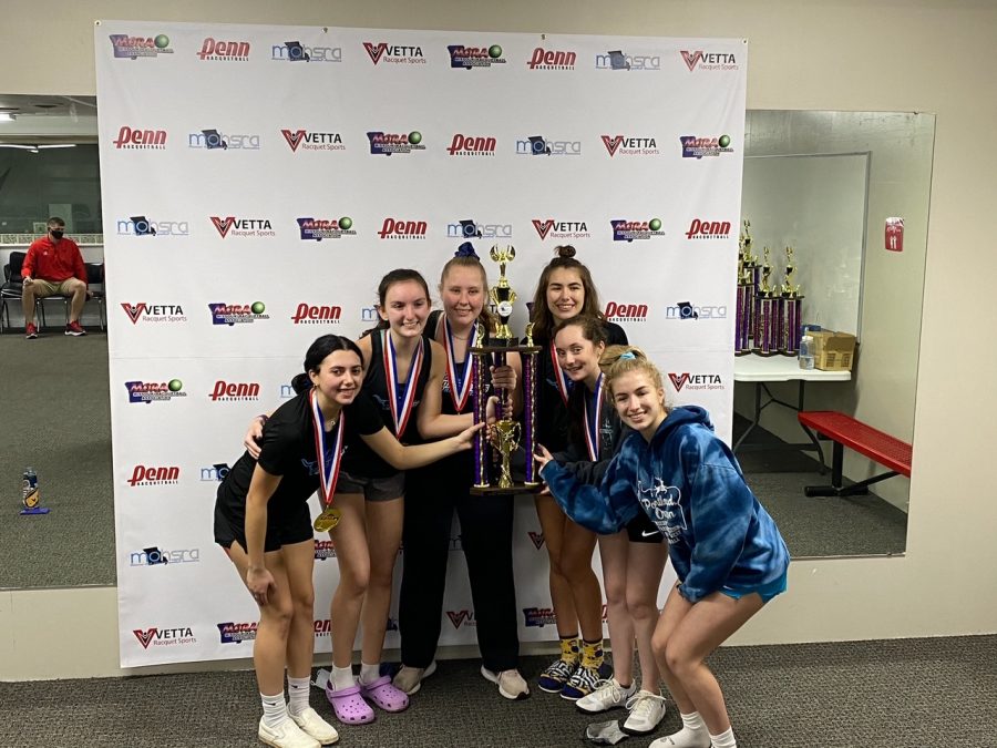 
Following a first place finish at the state tournament, the girls racquetball team celebrates their win by raising their trophy. The team participated in the JV1 bracket and hoped to move up to the varsity level next season. “It felt good to know that we were the best team on JV1, only making us more positive we are ready for varsity next year, at least with a lot of hard work,” junior Graci Badami said. “I think about all the varsity players from last year, and some of my teammates from this year, and I strive to do what they do so effortlessly. I also enjoy practicing and working to get better because it’s such a fun sport.” 