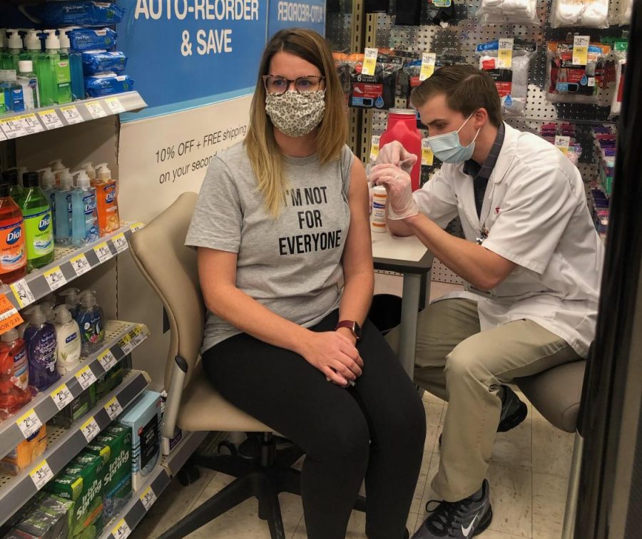Librarian Lauren Reusch receives her first dose at a Walgreens clinic. 
