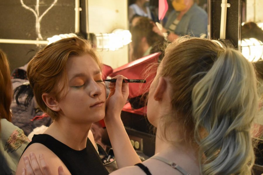 Getting makeup put on, freshman Ashley Lewinski and senior Anya Lewinski prepare for recording the theater department’s production of “The Spell of Sleeping Beauty.” The sisters play the red and green witches in the production which will be broadcasted to elementary schools on June 3. “I’ve always loved theater. I like getting out there and acting, meeting new people. Everyone from all different communities is so welcoming. I think it’s a great way to meet new people,” Ashley said.