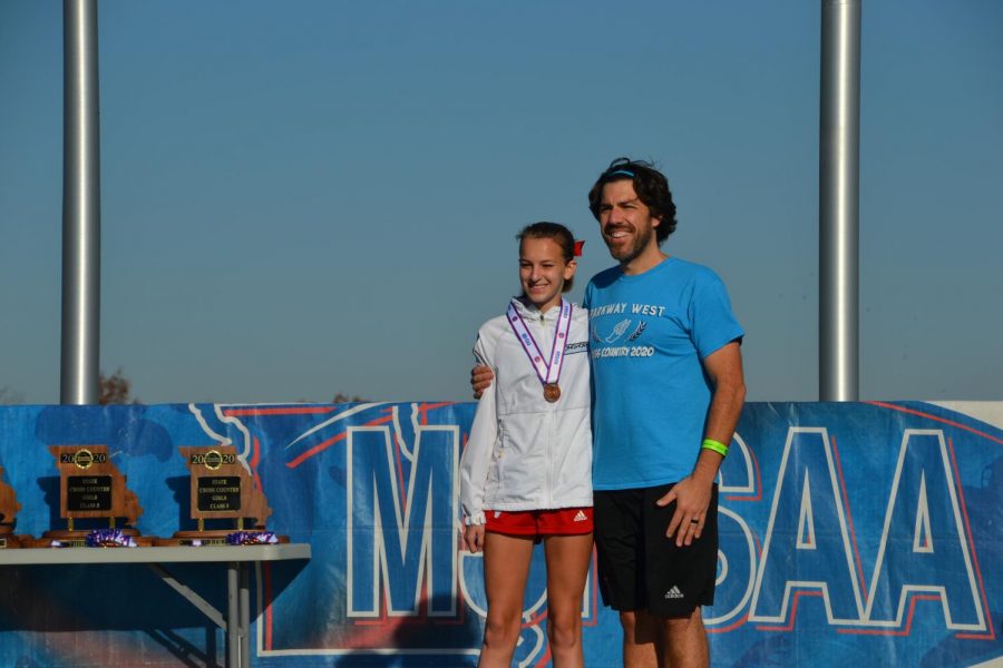 Junior Kathryn Yates poses with her cross country coach and science teacher Mr. Cutelli.