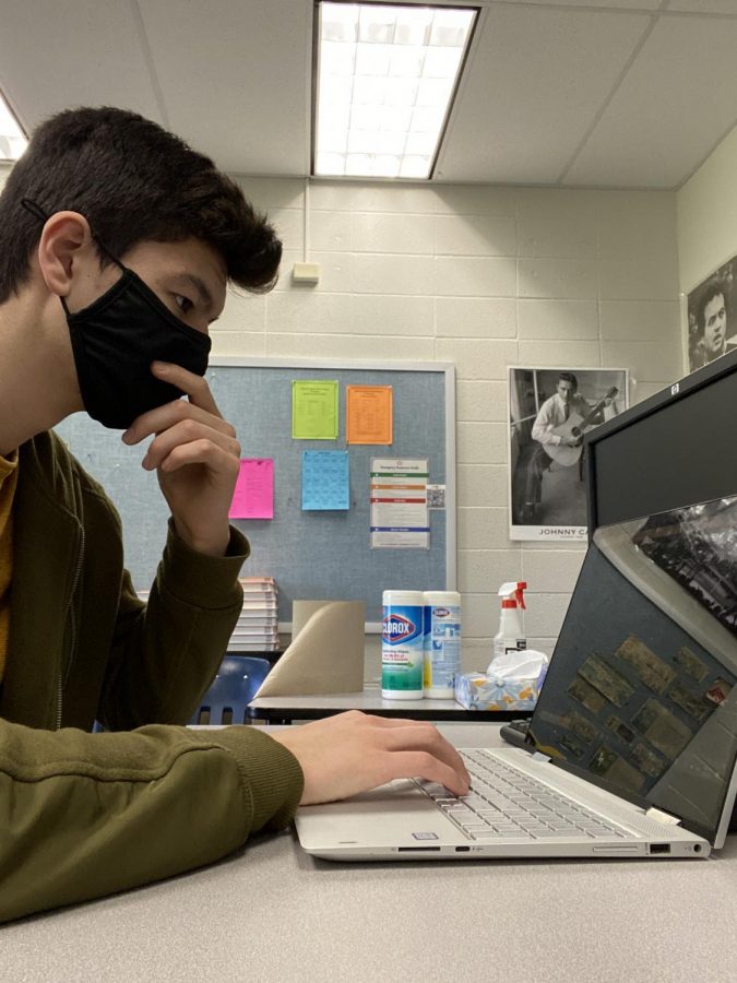 Senior Tengis Kelly works on coding a project while cadet teaching. 