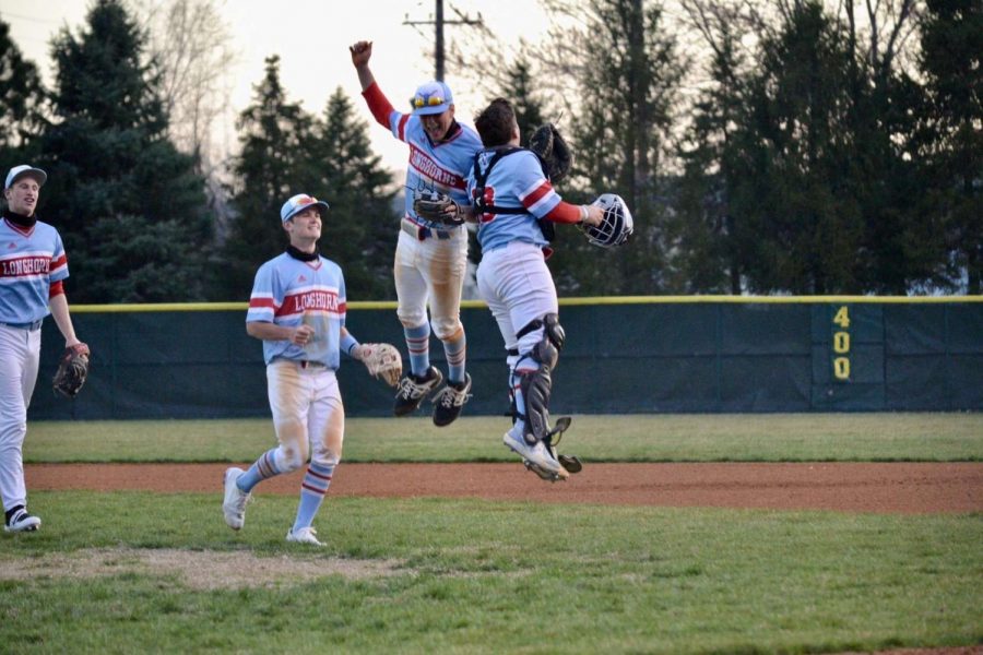 Celebrating the third win of the season, senior Elliot Krewson and sophomore Tyler Lang finish the game with a shoulder bump before leaving the field. The team beat SLUH 8-0, March 26, and began the season with three consecutive wins. “The beginning of the season made it clear that we would be special,” Lang said. “I think we all knew that we had a solid lineup and everyone had the intent of making it far into the playoffs.”