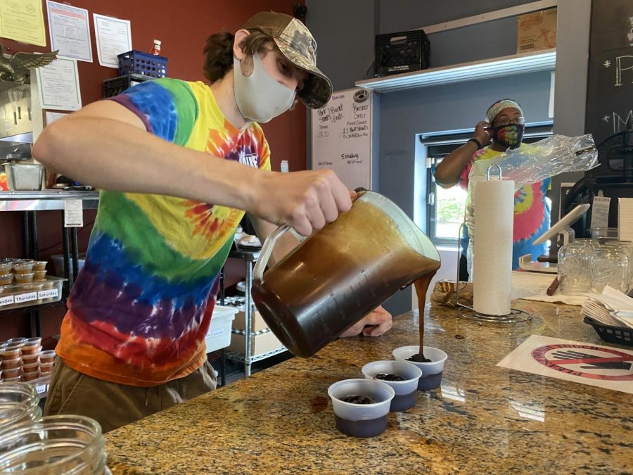 Pouring out sauce into individual containers, alumni Eli Basler performs this task daily. Since the beginning of COVID-19, Dalie’s stopped giving bottles of sauce to customers, and instead they must order the sauce with their food. “A lot of stuff has definitely slowed us down,” Eli said. “ We have had to do a little more work but it’s a good thing that we’re worried about our customers safety.”