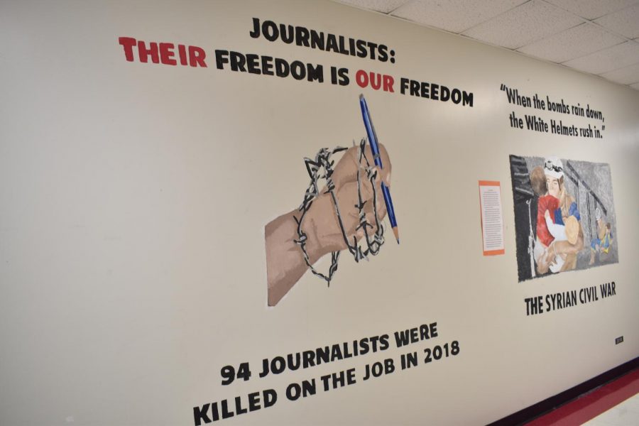 This mural, painted in the social studies hallway by the 2019 Challenges to Democracy class, commemorates 94 journalists were killed in targeted attacks, bombings and crossfire in 2018.