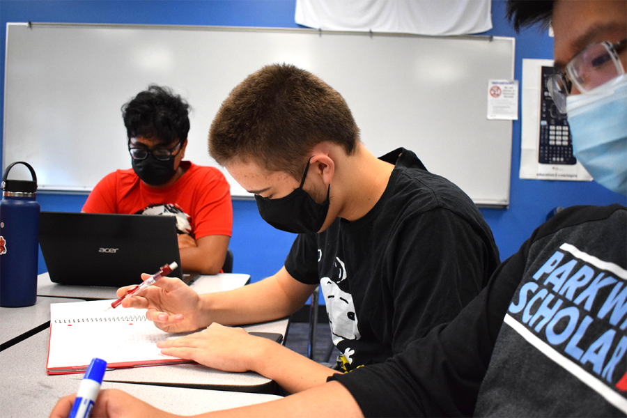 As senior Rick Biswas reads a packet, junior and Scholar Bowl Executive Captain Owen Arneson keeps track of senior Kevin Zhengs and the rest of his teammates points. Doing this at each of the Scholar Bowl teams practices three times a week allowed Arneson to figure out categories he and his teammates have improved in. Senior and Strategic Captain Anna Csiki-Fejer (not pictured) then helps players find resources to improve in categories the team doesnt cover as well. Im excited to go to tournaments, see some new people and competition, Arneson said. ​We were at a really good spot dedication-wise at the end of last season, but how much more dedication Im already seeing this year looks like a really good sign to me. I love seeing my teammates play well, show good teamwork and have a good time; it makes me really excited to see just how well we can do this year.​