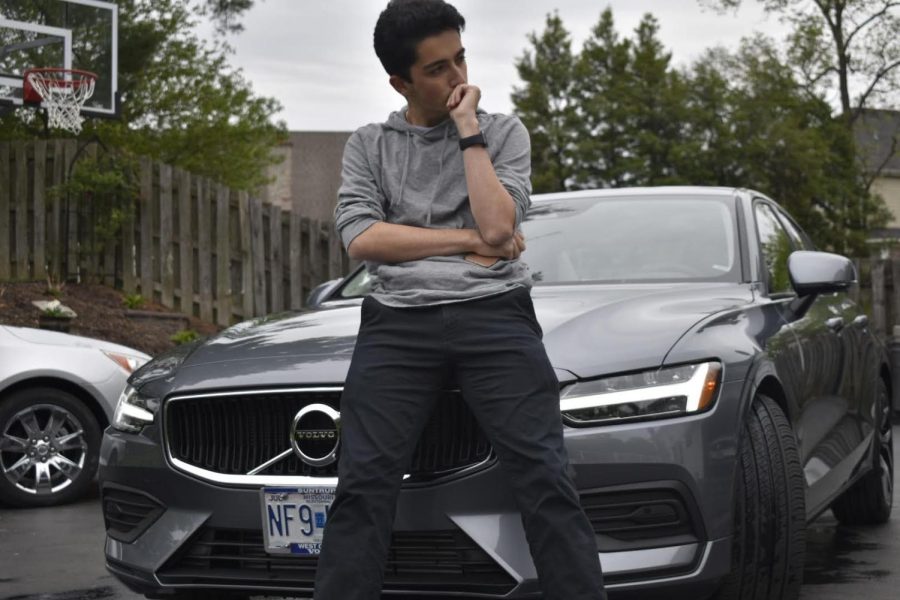 Senior Kayvon Rezaei poses with his Volvo after handwashing it. He initially thought washing cars was a daunting task but soon found enjoyment in the activity.  “I’ve never hand-washed my car before so this was a new experience,” Rezaei said, “I never thought about cleaning things such as the exhaust pipes or the wheels.”