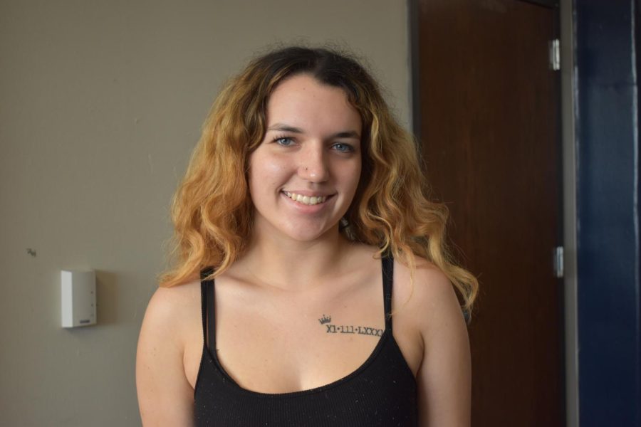 Senior McKayla Apollo shows of her roman numeral tattoo. 