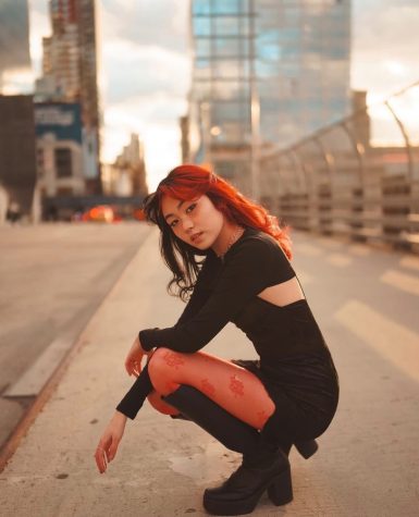 Wearing a red and black outfit to compliment her newly dyed hair, alumna Charlize Chiu poses along the streets of New York. Chiu later posted the photo to her Instagram account where she posts other photoshoots and styling videos. “Theres a lot of trial and error, like putting random pieces in my closet together and if it doesnt work out then Ill swap it out for something. There’s a lot of trying on clothes and then putting it back and seeing what works,” Chiu said. “I like to look up a lot of different inspirations on social media and Pinterest. When Im walking around the city I get inspiration from what Im seeing other people wear.”