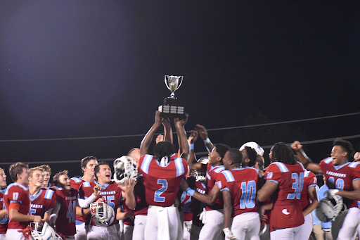 Varsity Football celebrates winning back the Mayor's Cup. 