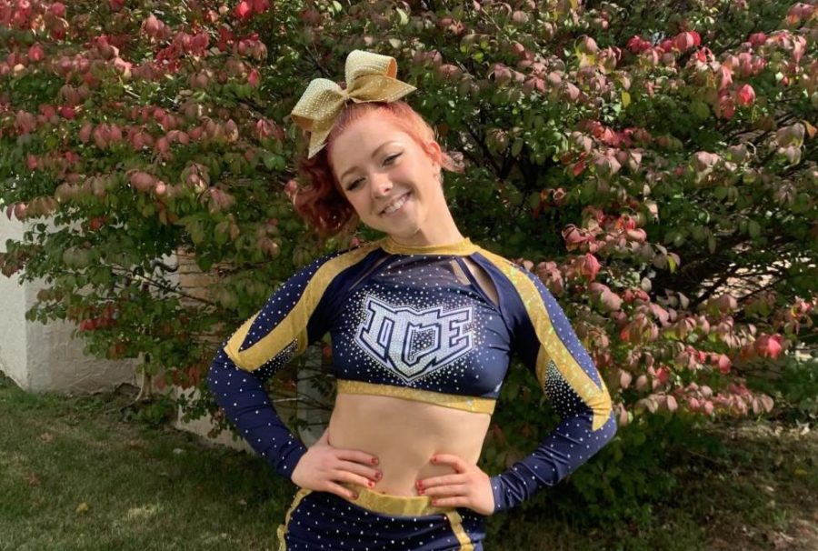 Senior Emily OConnor poses in her navy and gold cheer uniform at the ICE All-Stars competition. For years, OConnor looked up to the ICE athletes. I feel lucky to be able to take the mat with ICE across my chest. The owner has built such a well-oiled machine, and the coaches at ICE have helped me become a better person by their life lessons and examples.