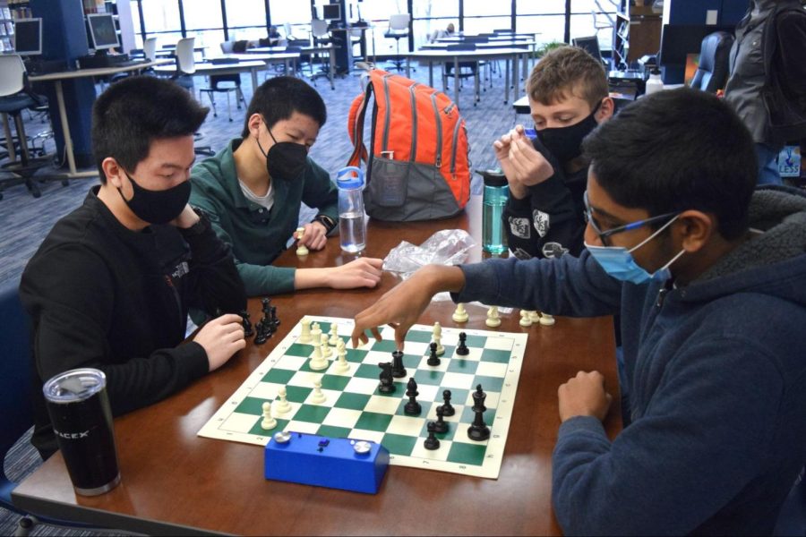 Juniors Wilson Gao and Alan Song and freshmen William Mayer and Prateek Nemmali play a timed match at chess practice during Academic Lab (Ac Lab). Gao appreciated Ac Lab practices as they provided a break from the rest of the school day. “Its just talking with people and playing well, just playing chess. People dont always know how to play chess, it can be a super foreign game. The interactions we have with people and how we can just play chess is fun,” Gao said.