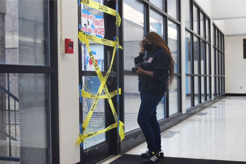 Sophomore Elizabeth Franklin stands outside of a door that is blocked off with caution tape due to nesting geese. Franklin planned on taking photos outside, but the number of students attacked by the geese has led to the outdoors being off-limits. “The geese have completely blocked us off from the outside world, and it’s interfering with our work as journalists. It’s unacceptable, and there needs to be a change,” Franklin said.