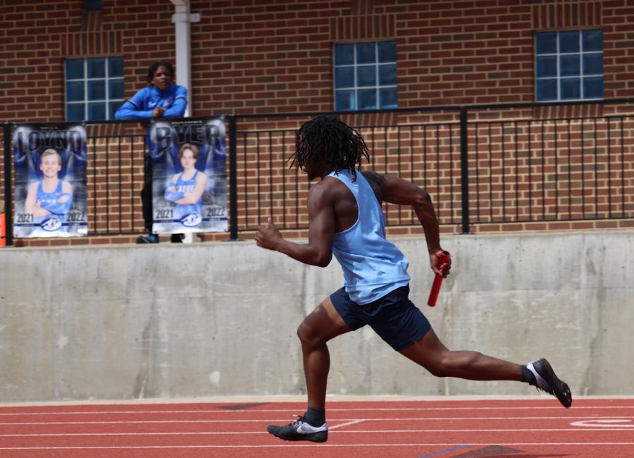 At the Suburban Conference Green Pool, a track and field competition at Ladue High School, senior Micah Harris starts the first leg in his 4x200 meter relay. Harris, along with seniors Ja’marion Wayne and Tre Bell and junior Brian Cambell, ran a time of 1:30:47 and placed first overall. “In the moment, all I could think about was running my quickest, so we could have a decent lead. It felt good seeing we placed first,” Harris said. 
