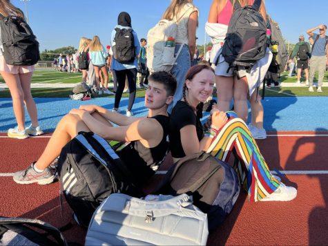 Juniors Ben Livak and Emily McClurg sit on the track after the fire alarm went off. Because class had not yet started, students gathered on the football field in groups with friends. “I had to make sure I grabbed all my stuff because I didn’t know what was gonna happen. Class hadn’t even started [when] we started heading outside,” Livak said. “[The process of being led back] was actually really smooth. I saw a little confusion with people trying to go different directions, but [teachers] got it under control.”