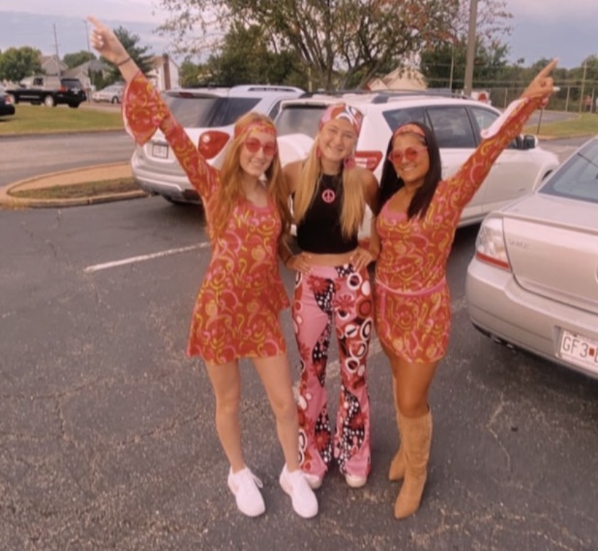 In the parking lot before school Thursday, Sept. 22, seniors Katie Jauss, Sarah Janssen and Hope Green celebrate the senior class theme of Disco. Disco day was my favorite [outfit]. I bought a head-to-toe outfit. I love dressing up,” Green said. 