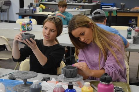 Checking her creation’s design, junior Natalie Sabbatini crafts a cactus clay mug in Ceramics 2. Ceramics class allows students to create projects they can use in everyday life. “It’s very therapeutic,” Sabbatini said. “I like how it’s very individual and it’s just working with yourself and your clay.”