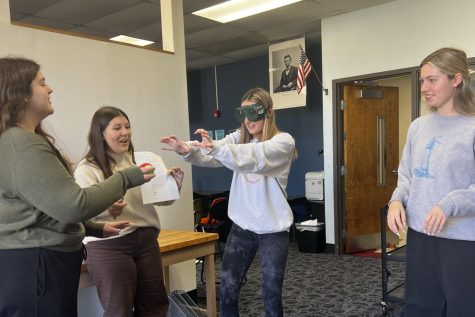 Wearing perception goggles, junior Norah Freed attempts to throw a tennis ball into a trash can. In AP psychology, students learned about the human senses and perception and how they could be altered. “When I put on the goggles, everything looked rainbow and there were blindspots everywhere. If the tennis ball was to the right, I reached to the left,” Freed said. “It was so funny watching everyone try to get the ball in the trash can. Nobody was even close.”