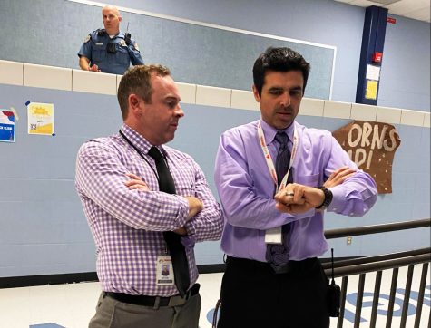 Principal John McCabe and Junior class Principal Mario Pupillo stand by the cafeteria door during lunch supervising. McCabe or another administrator monitors during every lunch period. “It’s stressful, but it’s also rewarding because we have such a great student body, and they’re mostly sitting here enjoying themselves and their lunch,” McCabe said. 
