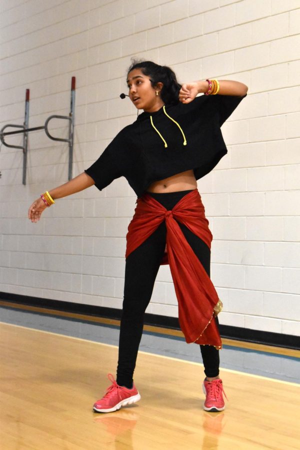 Sophomore Triya Gudipati teaches dance moves at her Bollywood dance night event, wearing a mixture of traditional and modern clothing. Gudipati wanted to wear comfortable dance clothing but still stay true to her culture to teach others about Indian tradition. “It was  fun to bring everyone together and dance as one. I felt like everyone had fun and learned things about dance,” Gudipati said.