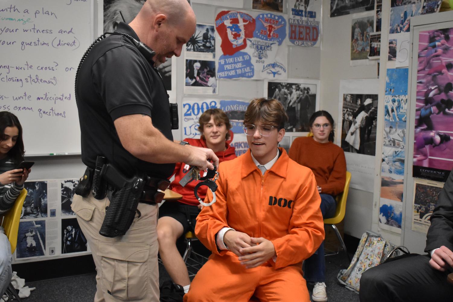 During a Crime and Law mock trial, senior Nadir Gheith acts as the defendant, Jack Percy who is on trial for the first-degree murder of Butch Burly. Officer Matthew Paubel removed Gheiths handcuffs at the start of the trial after escorting him to the pretend courtroom. “[The most challenging part of the mock trial] was seeing me lose because I hardly lose, and I needed to bounce back from that. [I lost] because the jury hates me. I don’t know what I did wrong, but they just didn’t like me,” Gheith said.