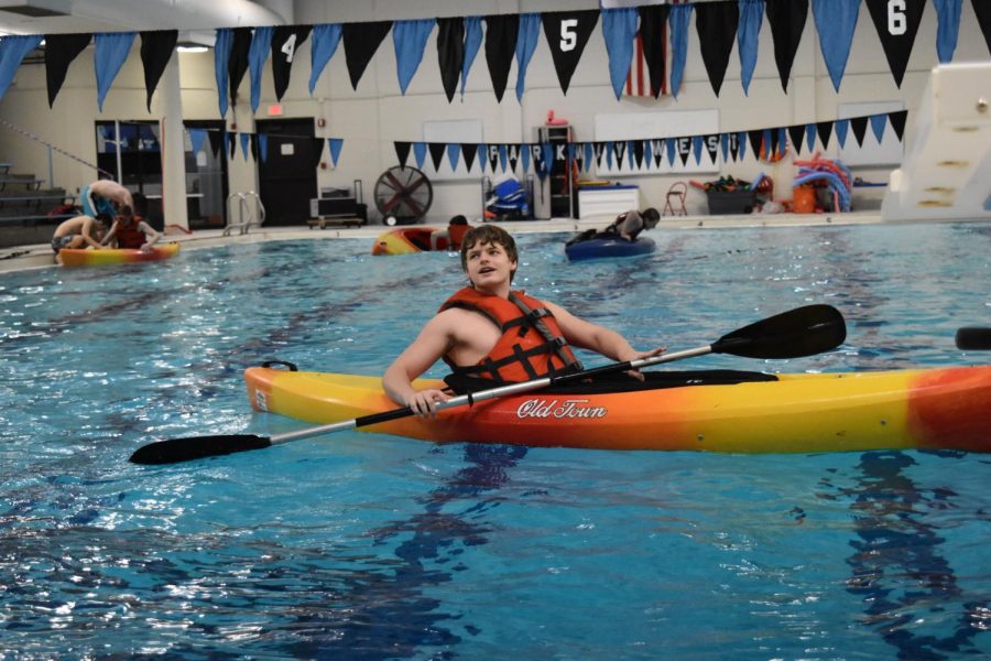 Practicing paddling backward, senior Trenton Caton talks with his friends, Jackson Larson, Tristan Wistuba and Braxton Eddy, about their favorite memories in the class. Caton favored the Scuba unit and spending time underwater, but he also liked kayaking because he got to play water polo after they were done with the lessons. “For vacation, we would go down to Michigan, and we would do a lot of kayaking there,” Caton said. “I started kayaking in fourth grade, so I have a lot of personal experience with it.” 