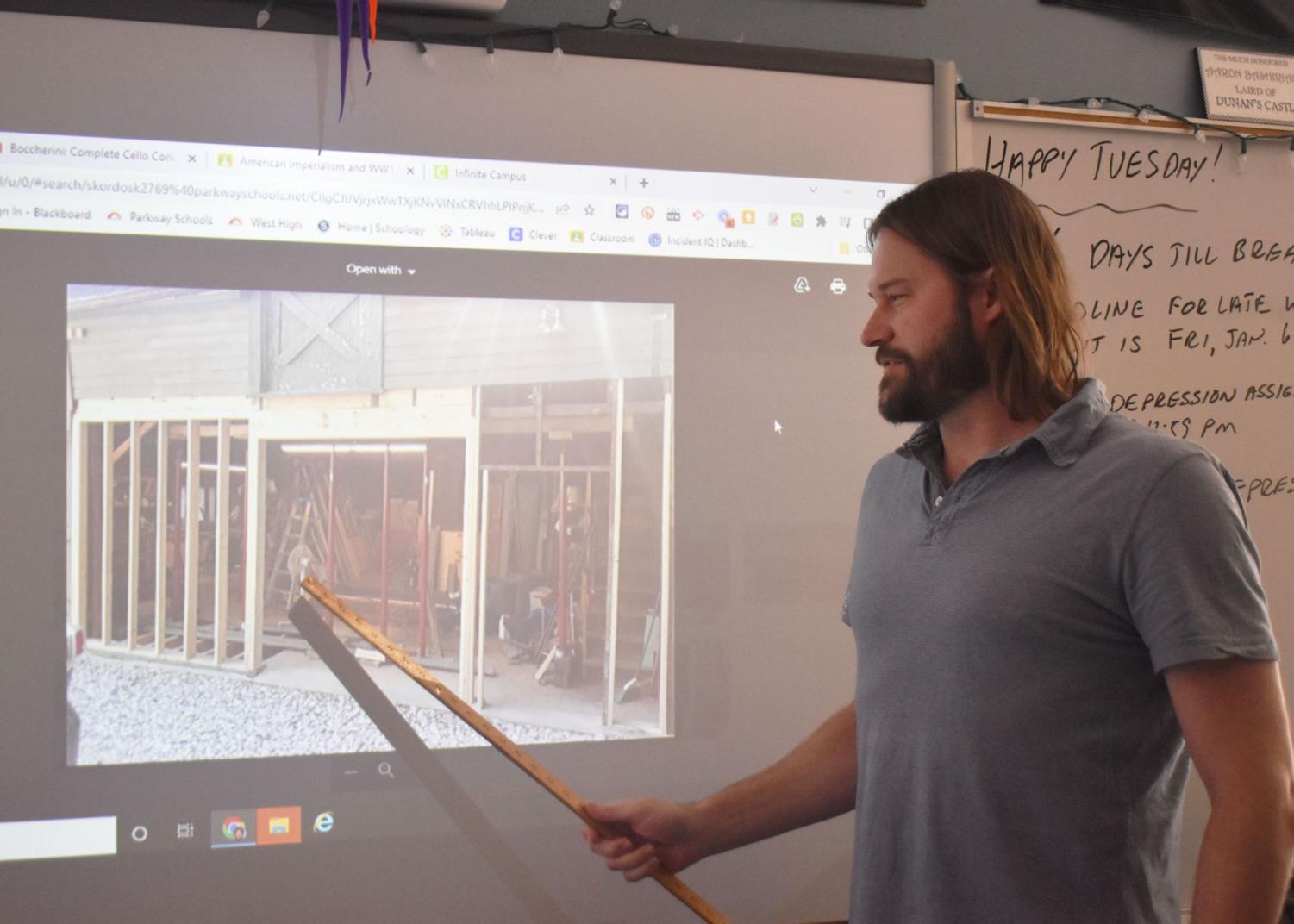 Eyes and ruler fixed towards the screen, social studies teacher Aaron Bashirian points to his Smartboard and explains the history behind his barn. Having learned the ropes of carpentry, Bashirian made structural changes to the barn by himself over the past three years. “It’s not your normal barn, but it’s cool, though. It’s got quite a bit of history to it,” Bashirian said. “It used to be a carriage house; you can see where they used to keep the horse. There’s still a grain [and] hay shoot [too]. They parked Model T-style cars [that created] all these oil slicks on the floor where they leaked. You can see that there’s a lot of history in there. I love it, [it’s a] perfect building for a history guy. ”