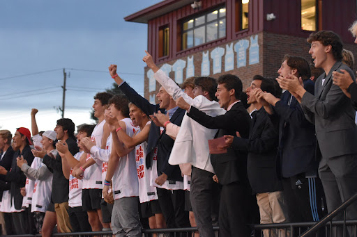The senior boys dress in suits and jerseys to cheer on the Powder Puff competitors. Senior Derrien Gatchel initiated the suit trend last Powder Puff season. “The thought process was [to pretend we were dressing for] a business trip. Since we won last year, we had to do it again this year,” Gatchel said. 