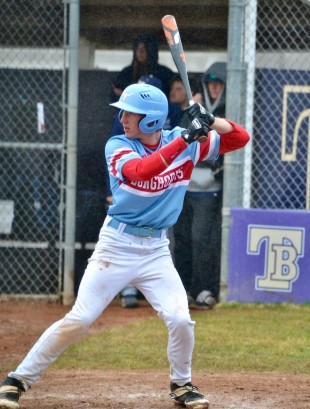 Senior Grant Meert dons school colors as he swings his bat for a fastball. 