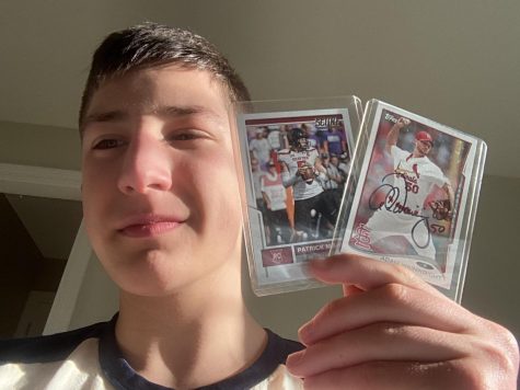 Sophomore William Gonsior smiles and holds up his two favorite cards featuring Kansas City Chiefs quarterback Patrick Mahomes II and St. Louis Cardinals pitcher Adam Wainwright.