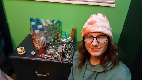 Senior Cass Isele shows off their colorful collection of Ramune bottles.