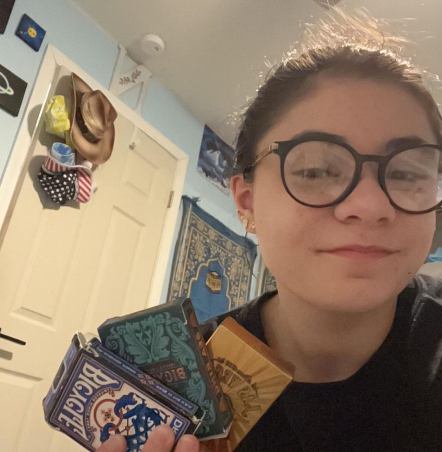 From the poolside to the classroom to a family game night, sophomore Neeka Naghibi Harat has a deck of cards for every occasion. Harat holds Dragon Back Blue, Sea King and Las Vegas decks, showing off her favorite playing cards.