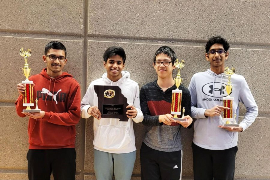 After winning their respective boards and collecting their awards, the chess team stands together, holding their trophies. Sophomore Prateek Nemmali (right) captained the team and led them to an overall second-place finish. “In terms of community, I feel [chess] is a nice team spirit-building thing, especially when playing in team tournaments. It’s competitive, but you feel together when you play the game,” Nemmali said. 