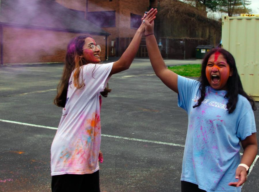 Juniors Riya Ashok and Puneeta Ganga give each other a high-five as they celebrate the Indian holiday Holi. Ganga, co-president of Indian Club, put on this event to introduce other students to the holiday and to have fun with friends. “Holi is a really fun celebration, and I believe it should be an experience that everyone can participate in,” Ganga said.