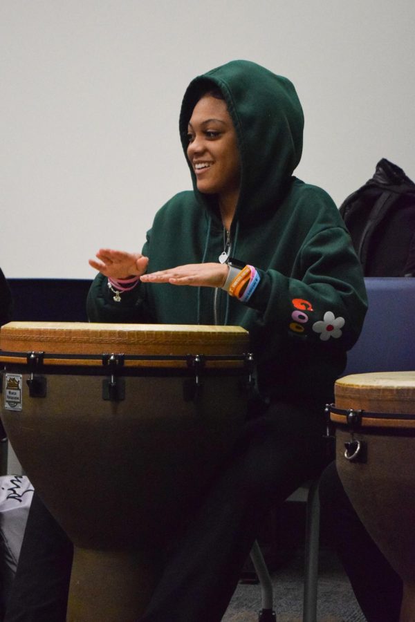 Laughing with her friends, sophomore Demecha Northcross learns how to play the drums at the African Drumming event in the library during Ac Lab. This event was hosted to share West African traditions and honor Black History Month. “[We were] beating on drums — who wouldn’t sign up to do that? It was an amazing experience; we made our beats to create one whole sound. I 10 out of 10 would recommend [students] sign up for this event if [they] are ever given the opportunity to do it,” Northcross said.